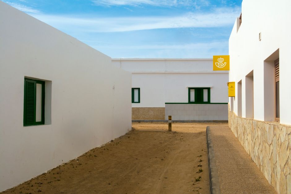 Exterior of a community health building in an urban neighbourhood with people entering